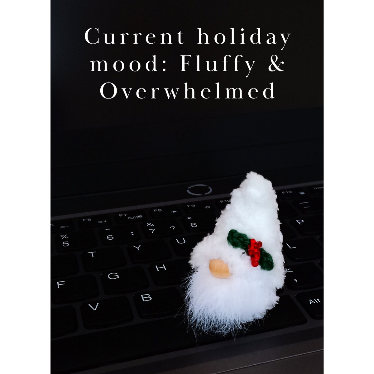 • A funny workplace digital download postcard. A cute fluffy white miniature Christmas gnome plush companion is placed on a sleek black laptop. The elegant centered typography reads: 'Current holiday mood: Fluffy & Overwhelmed'.
