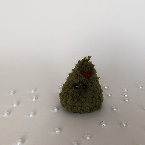 Tiny green crochet Christmas tree with red berry decoration surrounded by pearl accents, handmade miniature holiday decor
