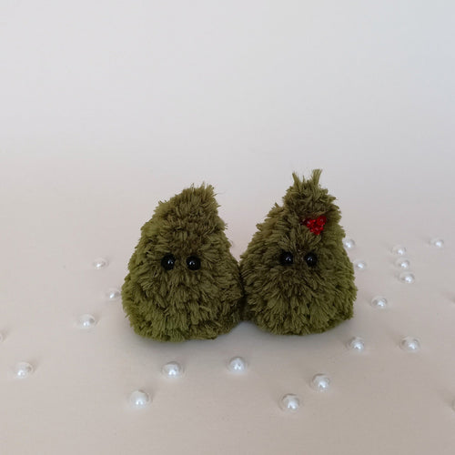 Two tiny handmade green crochet Christmas trees, one with red berry decoration, fluffy holiday desk companions
