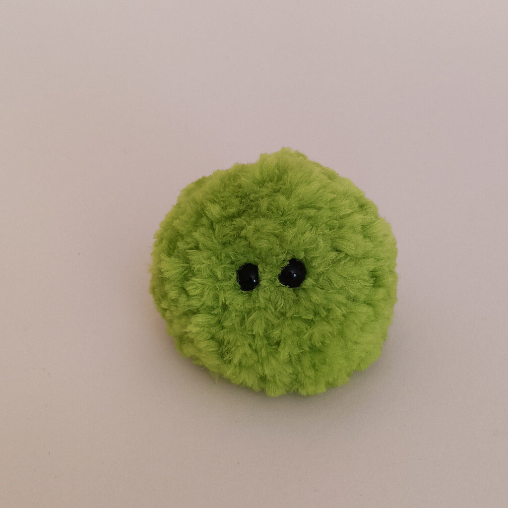 A bright lime green miniature moss plush toy on a clean neutral background. Aesthetic desk companion and cute stocking stuffer filler idea.