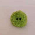 A bright lime green miniature moss plush toy on a clean neutral background. Aesthetic desk companion and cute stocking stuffer filler idea.