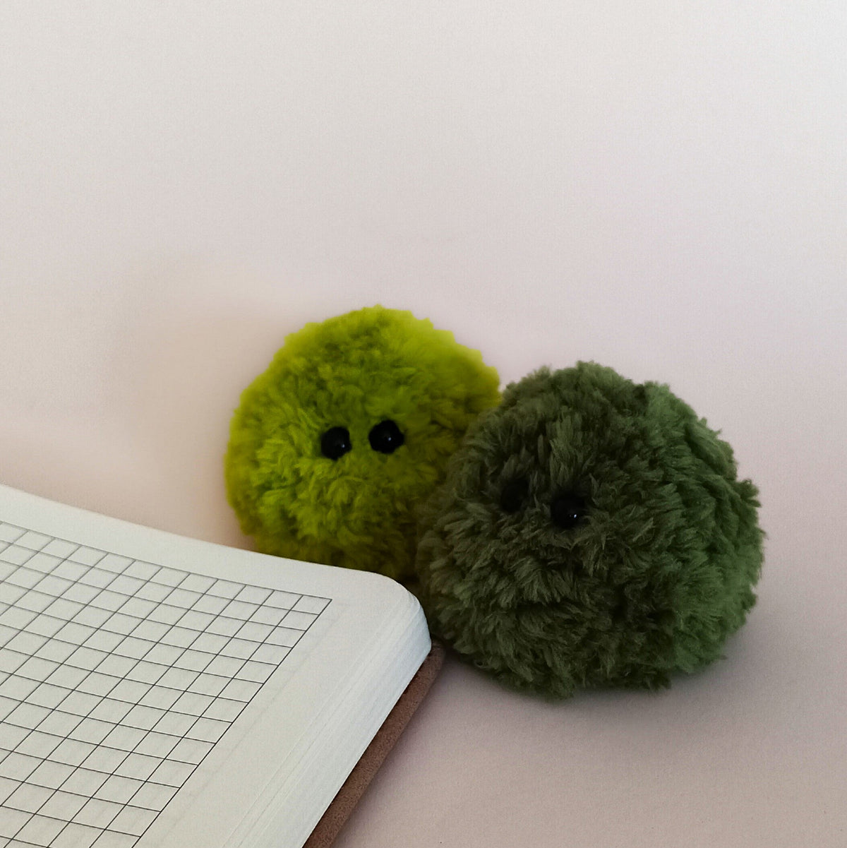 Four miniature fluffy moss plush friends in different shades of green, mint, and forest green. Perfect moss ball desk decor and cute desk pet set.