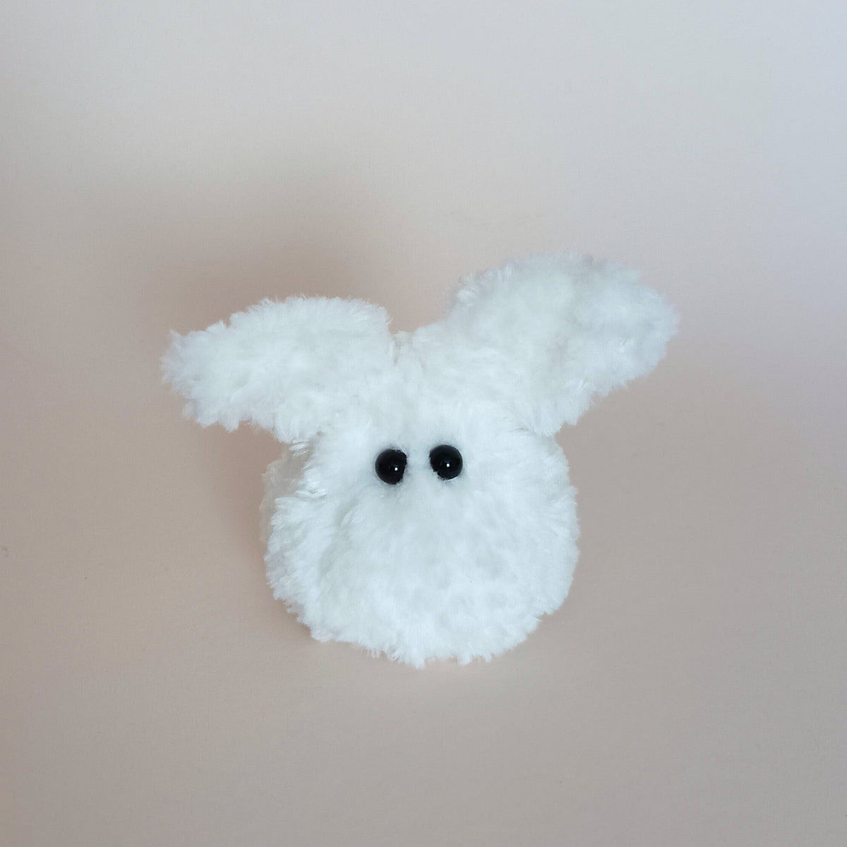 A miniature handmade white fuzzy bunny plush desk pet variation standing on a light background. Soft pocket size worry pet collectible and unique small holiday gift idea for coworkers by PlushWhisper.