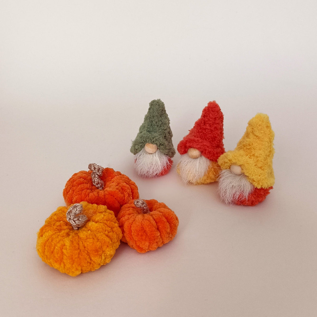 Available options for a full harvest set featuring three miniature handmade autumn gnomes in green, orange, and yellow next to three small plush pumpkins. Cozy fall tiered tray decor and a unique Thanksgiving gift bundle idea for adults.
