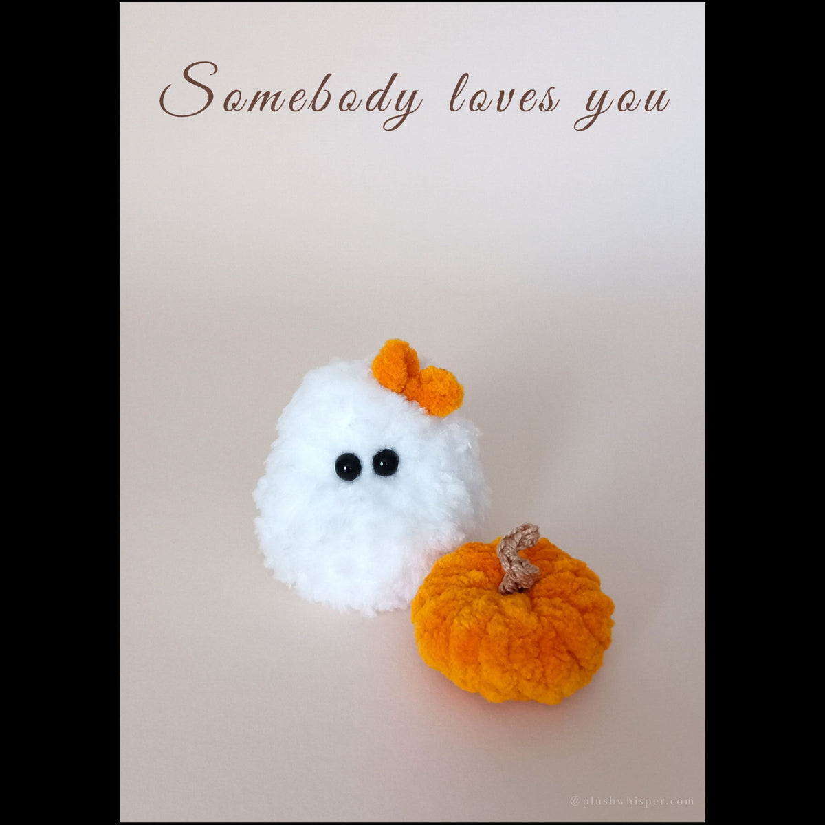 A 5x7 printable minimalist greeting card featuring a tiny white ghost handmade from fluffy plush crochet yarn with a vibrant orange bow and a small textile pumpkin. Solid light beige studio background with elegant empty space and clean chocolate brown typography that reads Somebody loves you at the top in a luxury wabi-sabi style.