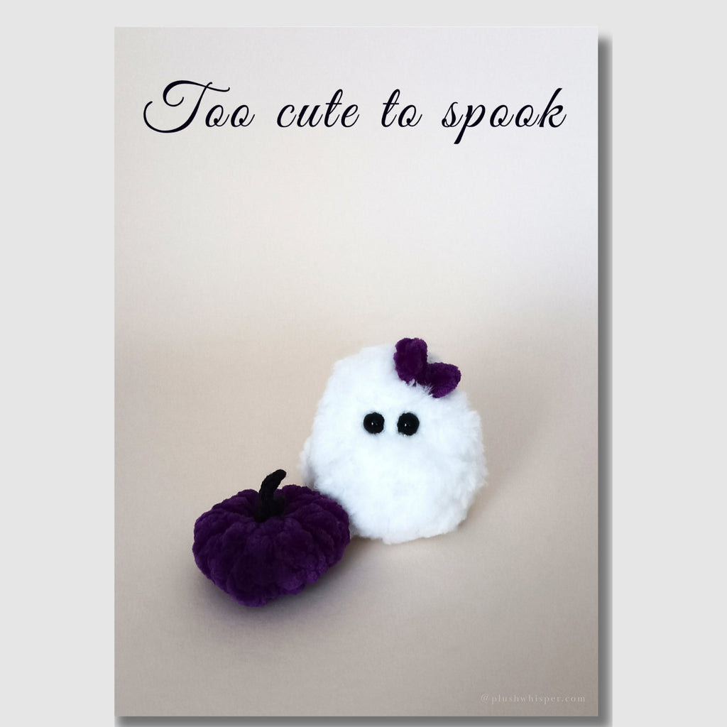 Printable Halloween card 5x7 inches with text Too Cute to Spook. High-resolution photo of an adorable fluffy crocheted ghost with a small purple bow and a miniature plush purple pumpkin.